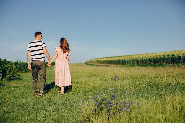 Beautiful couple spend time on a summer field