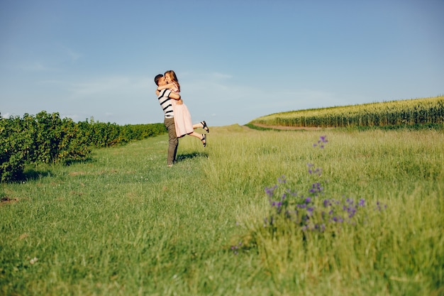 Beautiful couple spend time on a summer field