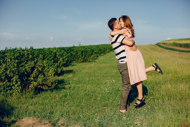 Beautiful couple spend time on a summer field