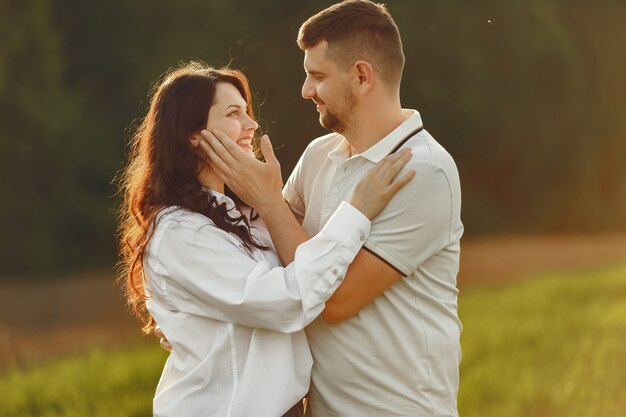 Beautiful couple spend time on a summer field