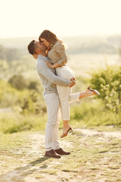 Beautiful couple spend time on a summer field