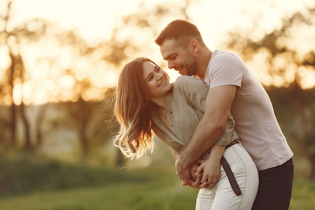 Free photo beautiful couple spend time on a summer field