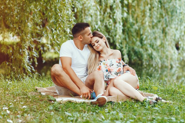 Beautiful couple spend time on a summer field