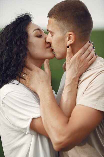 Beautiful couple spend time on a summer field