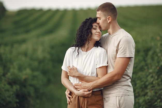 Beautiful couple spend time on a summer field