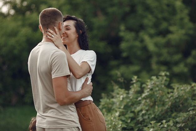 Beautiful couple spend time on a summer field