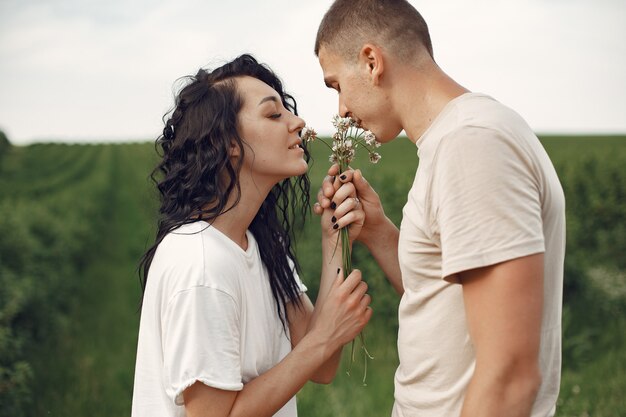 Beautiful couple spend time on a summer field