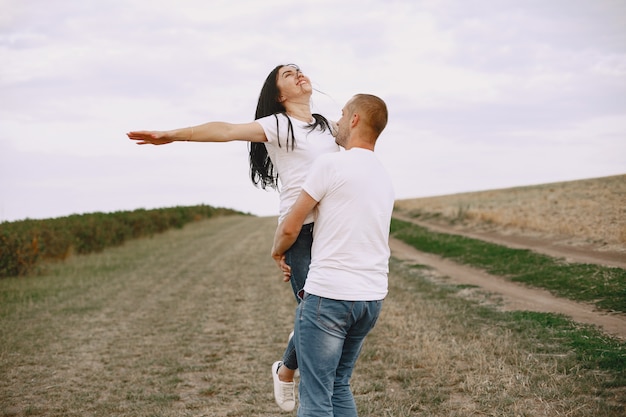 Beautiful couple spend time on a summer field