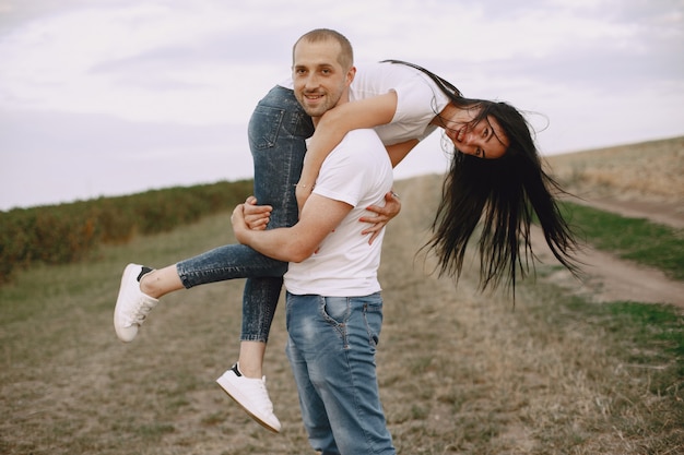 Beautiful couple spend time on a summer field