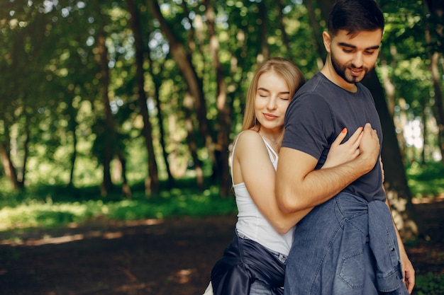 Beautiful couple spend time on a summer forest