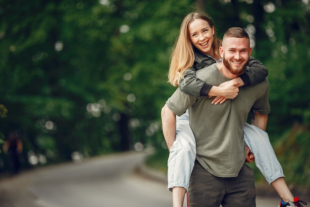 Beautiful couple spend time on a summer forest