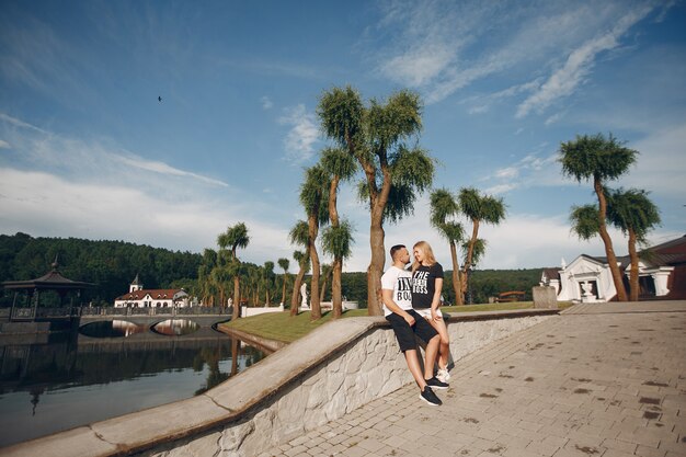 Beautiful couple spend time in a summer garden