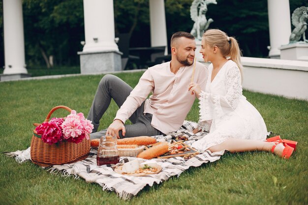 Beautiful couple spend time in a summer garden