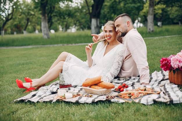 Free photo beautiful couple spend time in a summer garden