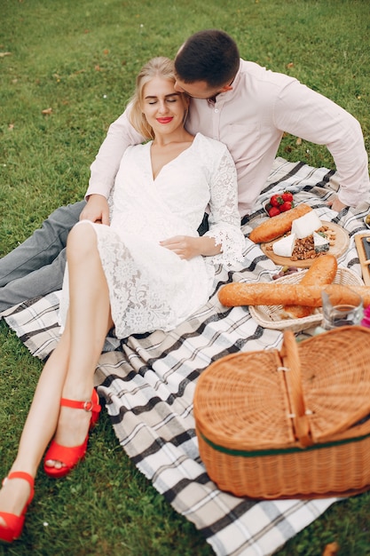 Beautiful couple spend time in a summer garden