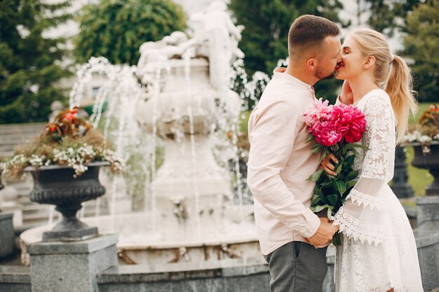 Beautiful couple spend time in a summer garden