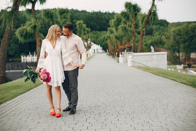 Beautiful couple spend time in a summer garden