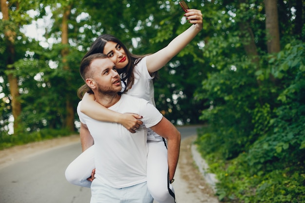 Beautiful couple spend time in a summer park