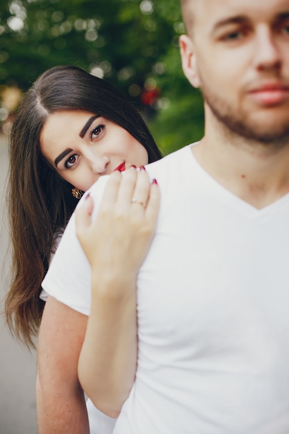 Beautiful couple spend time in a summer park