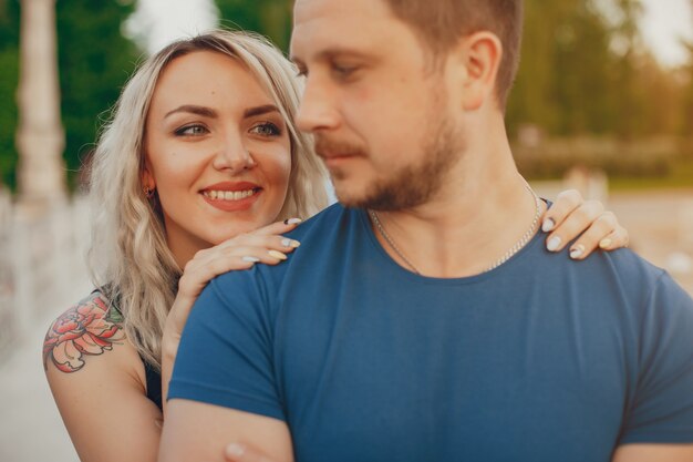 Beautiful couple spend time in a summer park