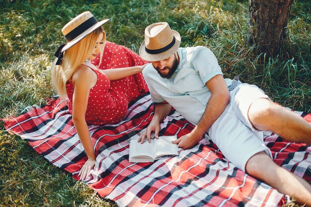 Beautiful couple spend time in a summer park