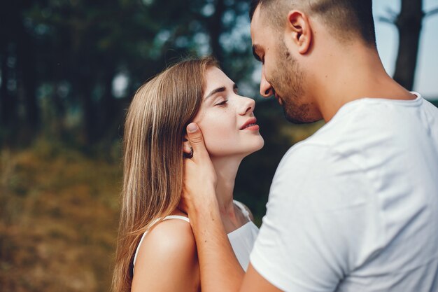 Beautiful couple spend time in a summer park