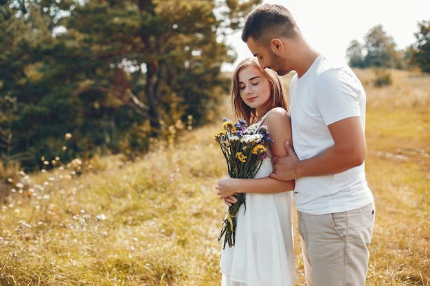 Beautiful couple spend time in a summer park