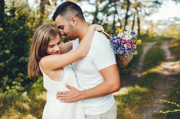 Beautiful couple spend time in a summer park