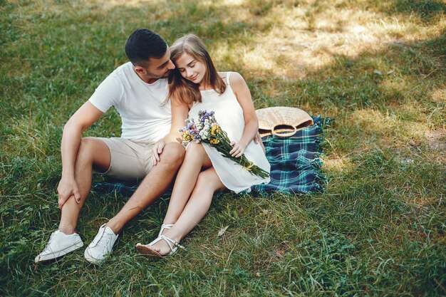 Beautiful couple spend time in a summer park