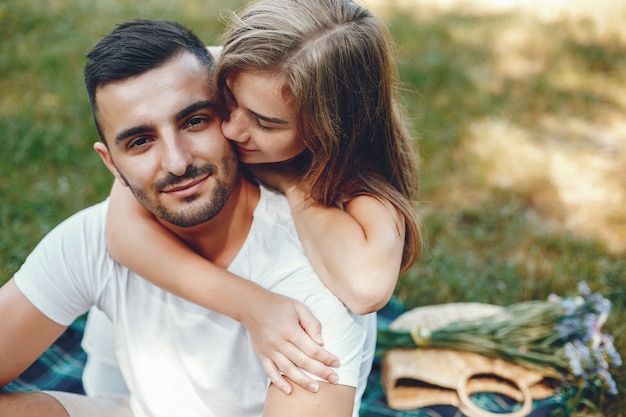 Beautiful couple spend time in a summer park