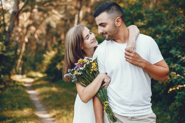 Beautiful couple spend time in a summer park