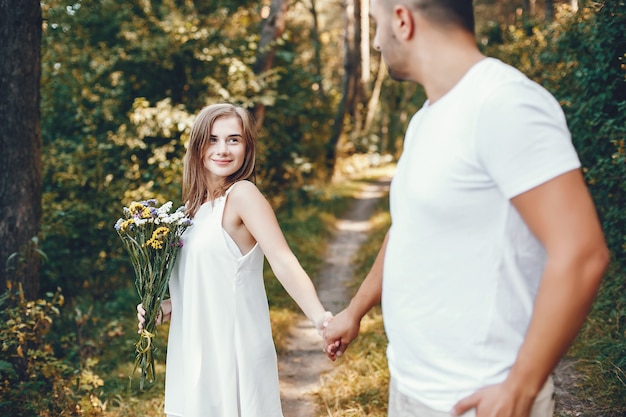 Beautiful couple spend time in a summer park