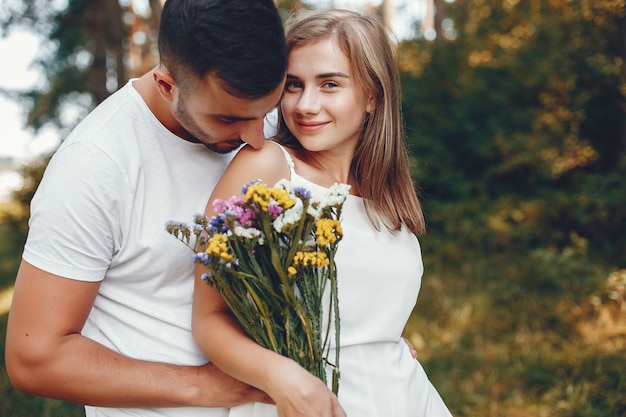 Beautiful couple spend time in a summer park