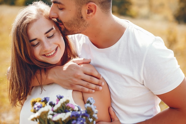 Beautiful couple spend time in a summer park