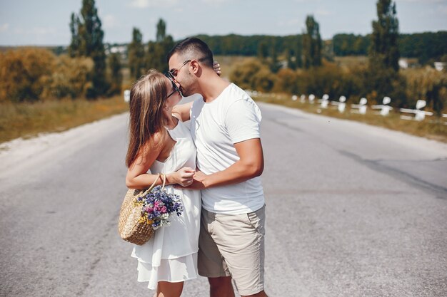 Beautiful couple spend time in a summer park