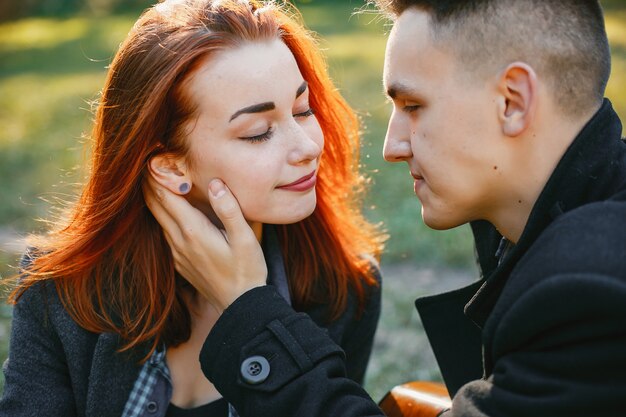 Beautiful couple spend time in a summer park