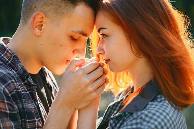 Beautiful couple spend time in a summer park