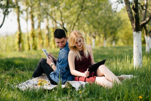 Beautiful couple spend time in a summer park