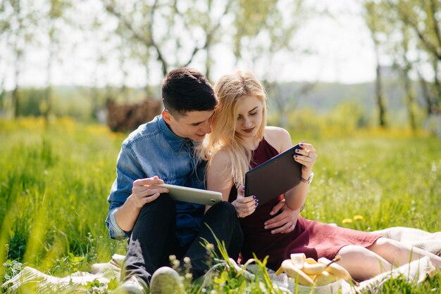 Beautiful couple spend time in a summer park