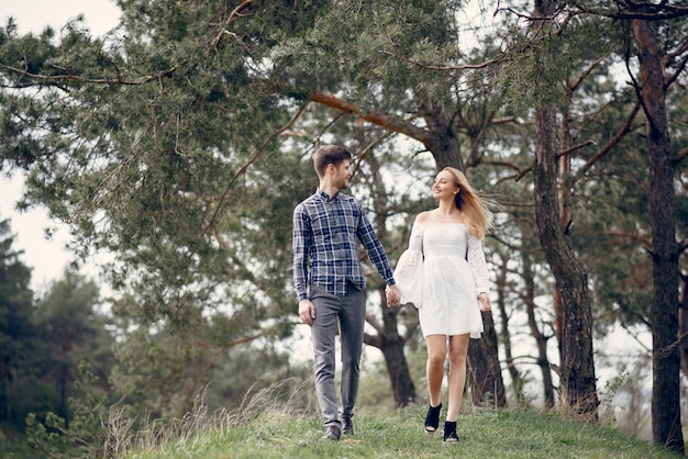 Beautiful couple spend time in a summer park