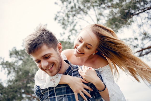 Beautiful couple spend time in a summer park