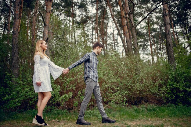 Beautiful couple spend time in a summer park