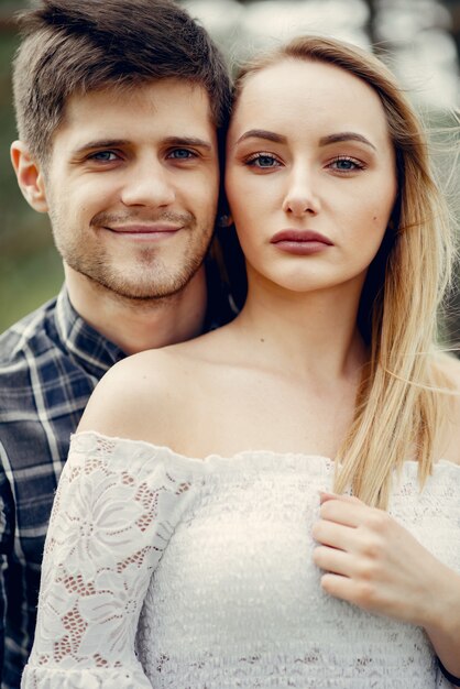 Beautiful couple spend time in a summer park