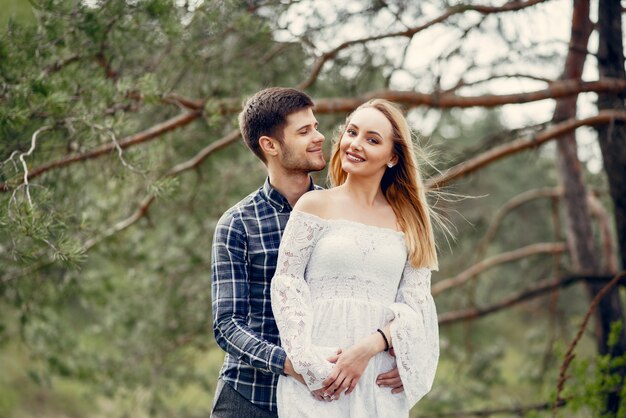 Beautiful couple spend time in a summer park