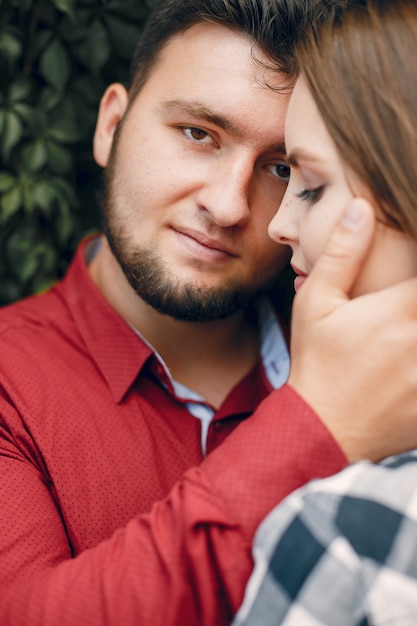 Beautiful couple spend time in a summer park