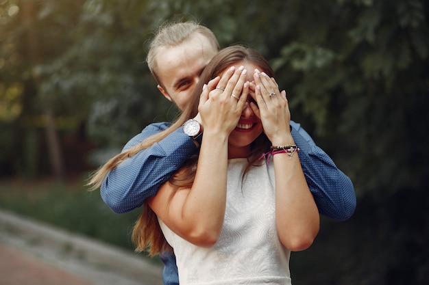 Beautiful couple spend time in a summer park