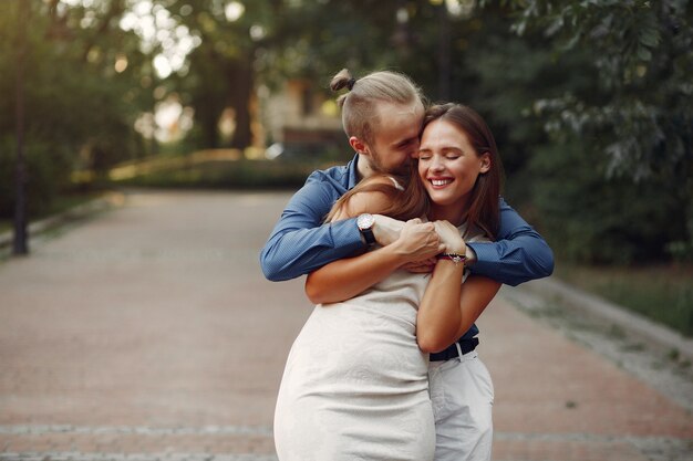 Beautiful couple spend time in a summer park