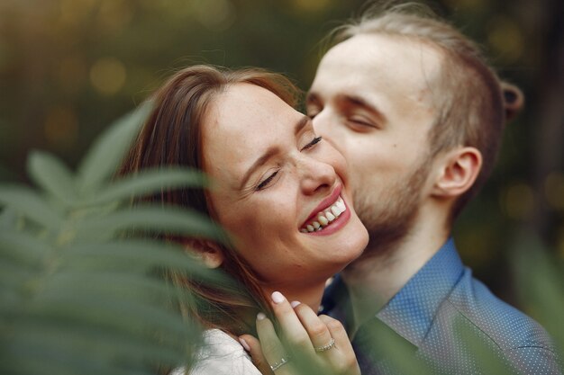 Beautiful couple spend time in a summer park