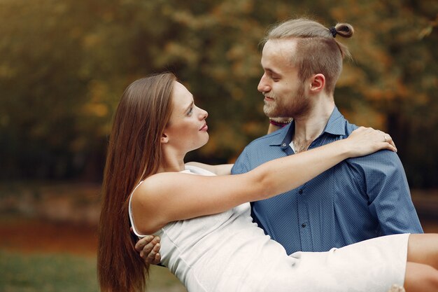 Beautiful couple spend time in a summer park