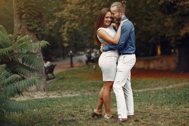 Beautiful couple spend time in a summer park